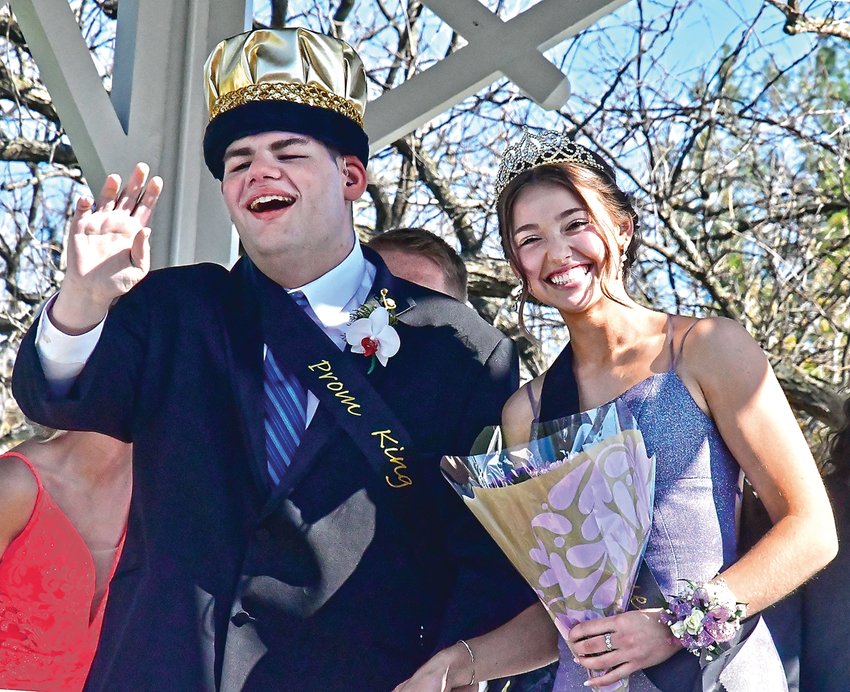 Newly crowned Prom King Ben Moyer waves to the crowd with newly crowned Prom Queen Maia Kropp, after the grand march at Grant Park on Saturday, May 7.